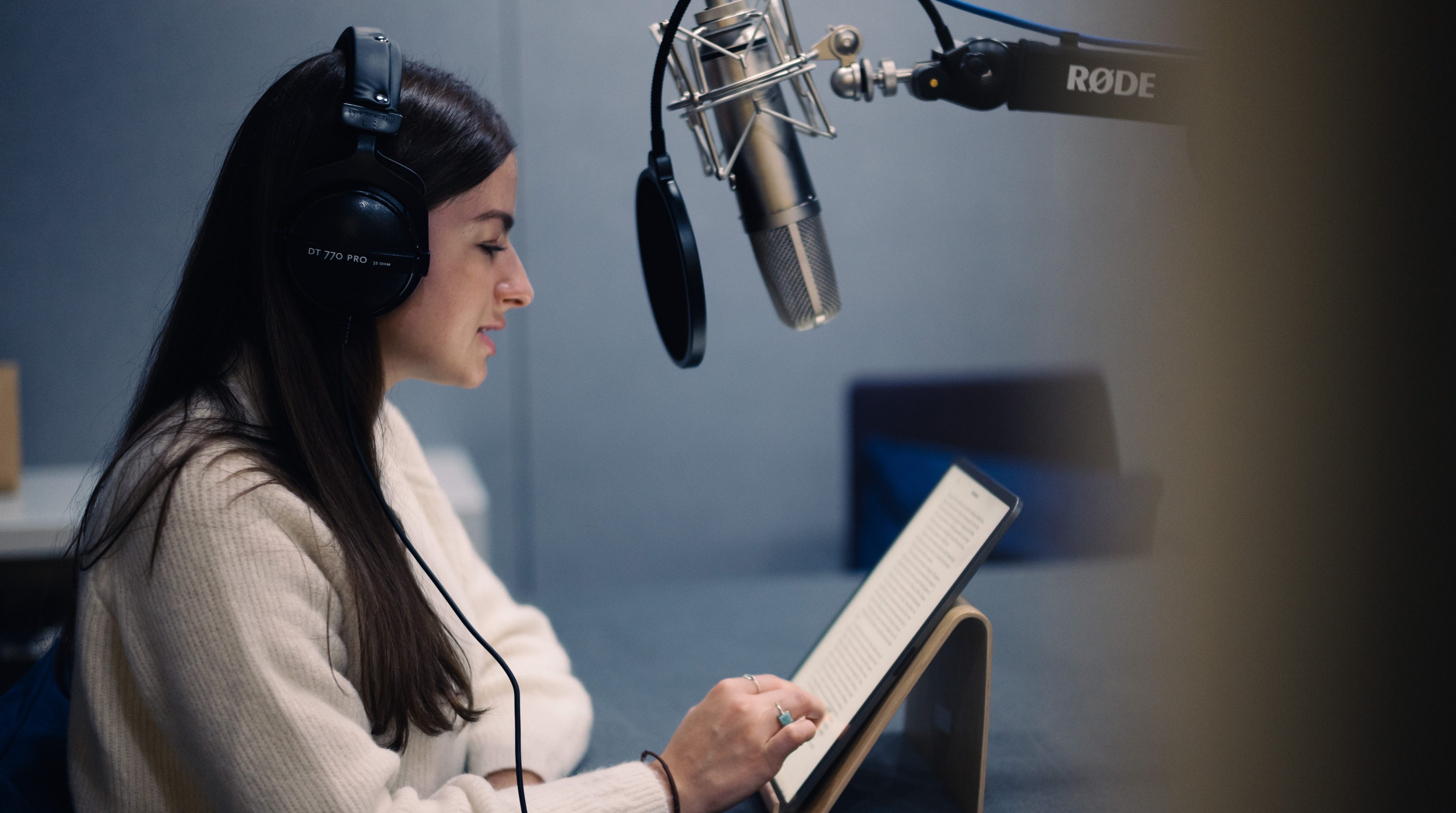 Image of a person in an audio studio recording